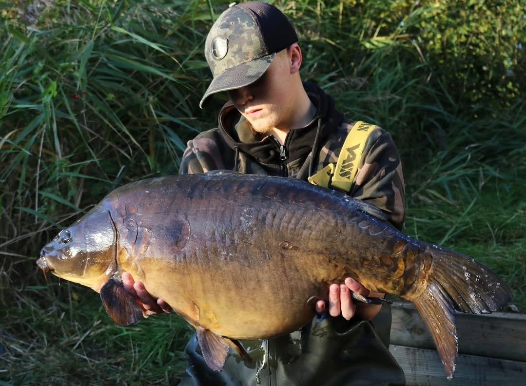 An Ashby Ville syndicate member holding a large mirror carp